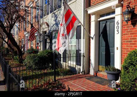 American flags, and the flag of Washington DC hanging outside townhouses in the Southwest Waterfront neighborhood. Stock Photo