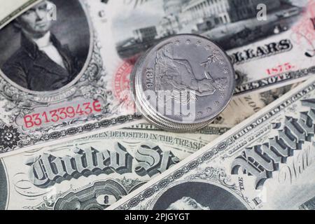 Old west period US banknotes and silver certificates with silver dollar coins Stock Photo