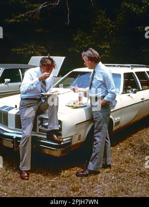 President Jimmy Carter and Vice President Walter Mondale get away from the crowd for a private talk while attending a church picnic at the Plains Baptist Church. - To license this image, click on the shopping cart below - Stock Photo