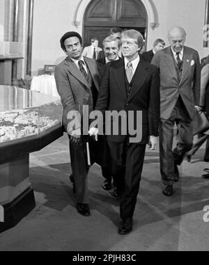 President Jimmy Carter flanked by his Ambassador to the United Nations, Andrew J. Young (left), walk into a meeting at The Smithsonian Institution's Castle building. 1978 - To license this image, click on the shopping cart below - Stock Photo