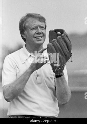 Jimmy Carter plays softball in his hometown of Plains, Georgia. Carter was pitcher and captain of his team that was comprised of off duty U.S. Secret Service agents and White House staffers. The opposing team was comprised of members of the White house traveling press and captained by Billy Carter, the president's brother. - To license this image, click on the shopping cart below - Stock Photo