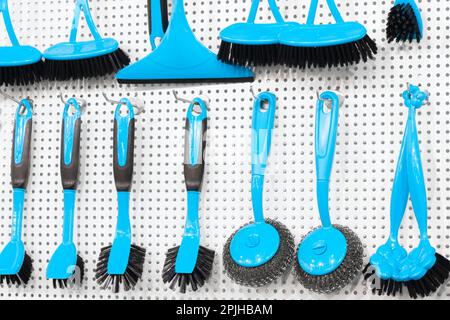 kitchen brushes hang in supermarket Stock Photo