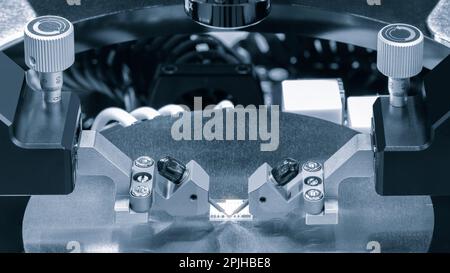 Close up of examining of test sample of microchip transistor under the microscope in laboratory. Equipment for testing microchips. Automation of produ Stock Photo