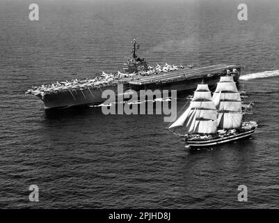 The U.S. Navy aircraft carrier USS Independence (CVA-62) underway with the Italian Marina Militare training ship Amerigo Vespucci on 12 July 1962. Independence, with assigned Carrier Air Group 7 (CVG-7), was deployed to the Mediterreanean Sea from 19 April to 27 August 1962. Stock Photo