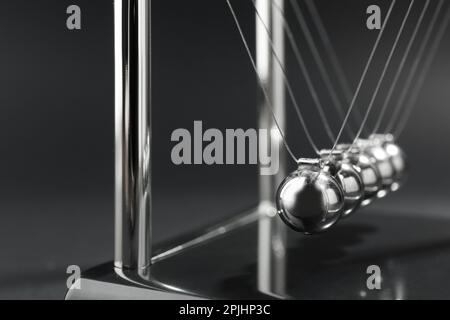 Newton's cradle on dark background, closeup. Physics law of energy conservation Stock Photo