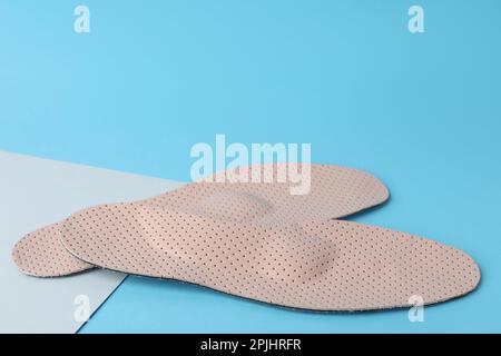 LIght blue and beige orthopedic insoles on white background Stock Photo ...