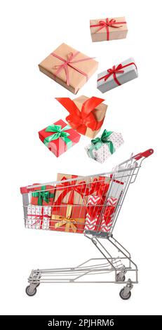 Beautifully wrapped gift boxes falling into metal shopping cart on white background Stock Photo