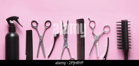 Set with scissors and other hairdresser's accessories on pink background, flat lay. Banner design Stock Photo