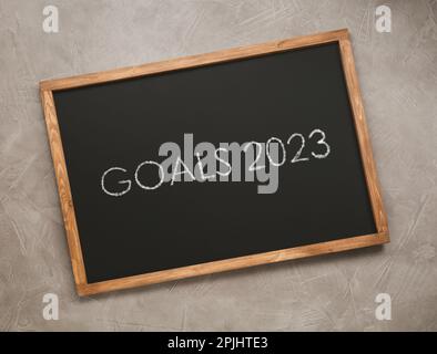 Blackboard with phrase GOALS 2023 on light grey stone background, top view Stock Photo
