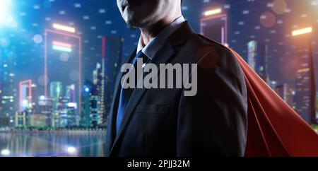 Young businessman in red cape and smart city background Stock Photo