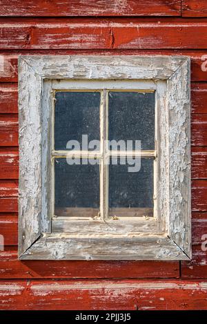 Closeup of a window on an old, weathered barn on the prairies in Saskatchewan Stock Photo