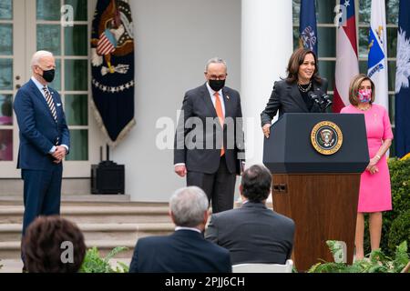 President Joe Biden, Senate Majority Leader Charles “Chuck” Schumer, D-N.Y., and House Speaker Nancy Pelosi, D-Calif., look on as Vice President Kamala Harris delivers remarks on the American Rescue Plan Friday, March 12, 2021, in the Rose Garden of the White House. (Official White House Photo by Adam Schultz) Stock Photo