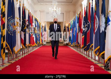 President Joe Biden walks from the State Dining Room of the White House to a podium in the Cross Hall of the White House Thursday, March 11, 2021, to deliver remarks on the one year anniversary of the COVID-19 Shutdown. (Official White House Photo by Adam Schultz) Stock Photo
