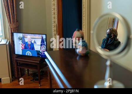 Vice President Kamala Harris watches as President Joe Biden delivers remarks on the American Rescue Plan Saturday, Feb. 27, 2021, from her office in the Eisenhower Executive Office Building at the White House. (Official White House Photo by Lawrence Jackson) Stock Photo