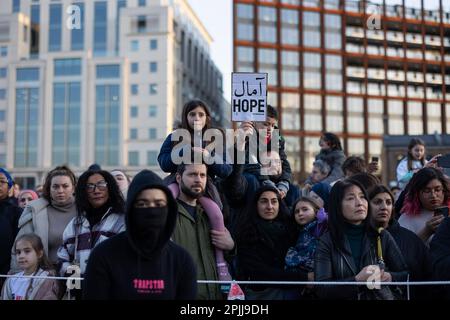 London, UK. 02nd Apr, 2023. People are seen gathered at Granary Square at King Cross in London to see Little Amal, another holds a placard written 'Amal' in Arabic. Little Amal has come back to London during passover and the month of Ramadan. Little Amal is a 3.5 metre-tall puppet created in 2021 and representing a Syrian refugee child, whose journey began close to the Turkish-Syrian border, travelling 8,000 km across Europe to the UK in support of refugees. (Photo by Hesther Ng/SOPA Images/Sipa USA) Credit: Sipa USA/Alamy Live News Stock Photo