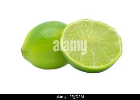 Whole and sliced fresh lime isolated on a white background. Lime on a white background. Cut green lime isolated. Stock Photo