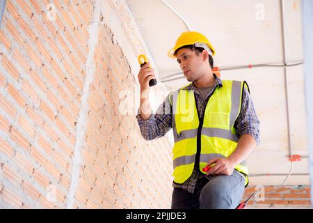 Young engineer caucasian man repair electricity at house, electrician fix and maintenance while inspection voltage with meter equipment at home, male Stock Photo