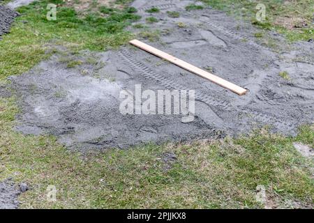 Using level for leveling sand when preparing platform for installation ...