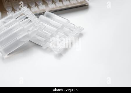 Single dose ampoules of sterile isotonic sea water solution on white background. Space for text Stock Photo