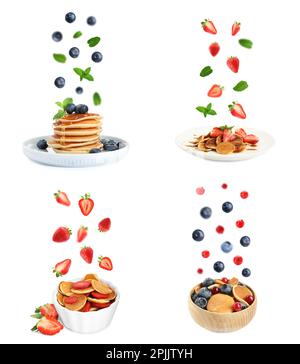 Set of delicious pancakes and different falling berries on white background Stock Photo