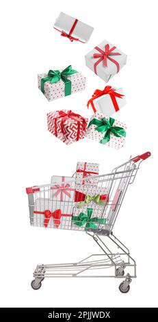 Beautifully wrapped gift boxes falling into metal shopping cart on white background Stock Photo