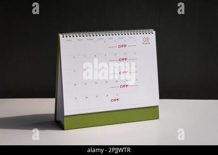 Red color words, Off Day on Fridays, Saturdays and Sundays printed on desk calendar. Four day work week concept. Stock Photo