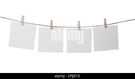 Clothespins with empty notepapers on string against white background. Space for text Stock Photo