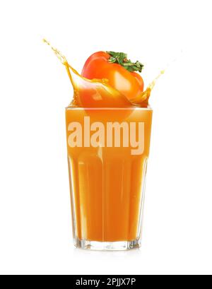 Tasty sweet persimmon falling into glass of juice with splash on white background Stock Photo
