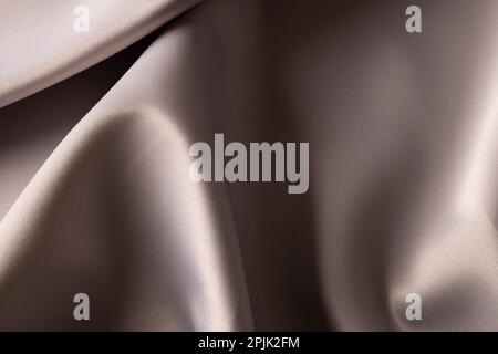 Close up of plain grey satin fabric with folds, copy space Stock Photo