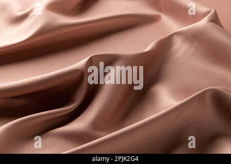 Close up of plain beige satin fabric with folds, copy space Stock Photo