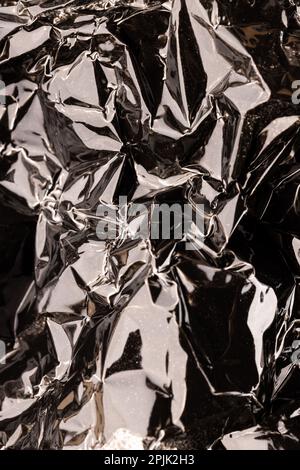 Close up of crumpled and shiny gold foil with copy space Stock Photo