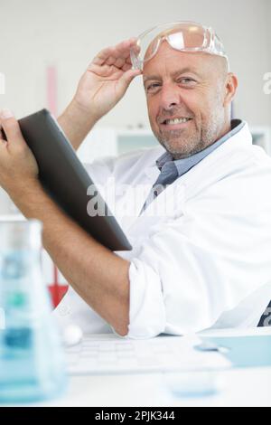 senior scientist holding a tablet pc Stock Photo