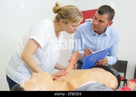 woman demonstrating cpr on training dummy Stock Photo