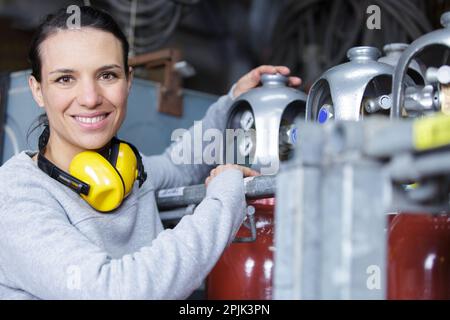young woman smiling confidently at camera enjoying work Stock Photo