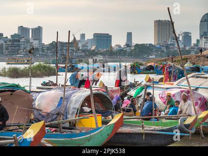 Phnom Penh,Cambodia-December 24th 2022:On the much less developed eastern side of the river,people live and work in canoe style craft,partially covere Stock Photo