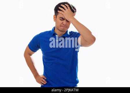 Portrait of sad young man with hand on head against white background Stock Photo