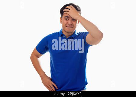 Portrait of disappointed young man with hand on head against white background Stock Photo