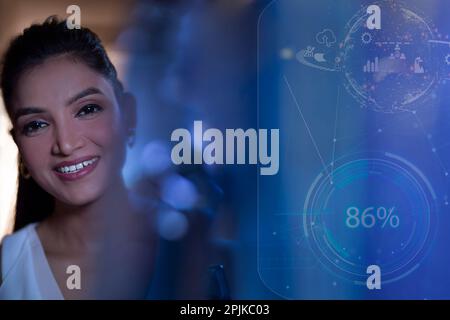Businesswoman Smiling with icons on virtual screen Stock Photo