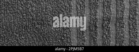 Gray terry towel fabric texture banner. Textile background, top view panoramic web header. Wide screen wallpaper Stock Photo