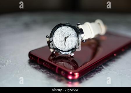 wrist watch on the black glass table. stylish watch photo. water drops on the table. luxury watch. clock Stock Photo