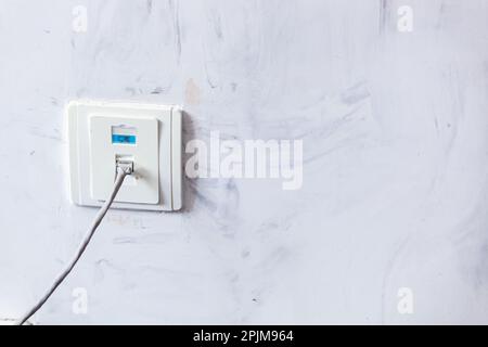 A smeared gray wall with an Internet outlet and dark translucent strokes. Background. Banner. Texture. High quality photo Stock Photo