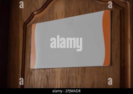 White plaque on brown wooden doors Stock Photo
