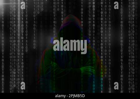 Silhouette of anonymous hacker and digital binary code on dark background. Cyber attack concept Stock Photo
