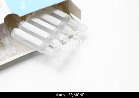 Package with single dose ampoules of sterile isotonic sea water solution on white background, closeup. Space for text Stock Photo