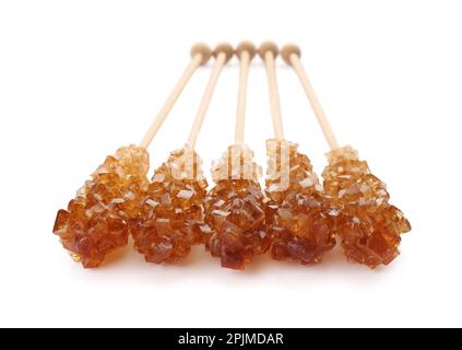 Wooden sticks with sugar crystals isolated on white. Tasty rock candies Stock Photo