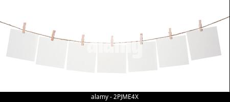 Clothespins with empty notepapers on string against white background. Space for text Stock Photo