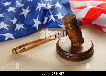 Judge's gavel and American flag on light wooden table Stock Photo