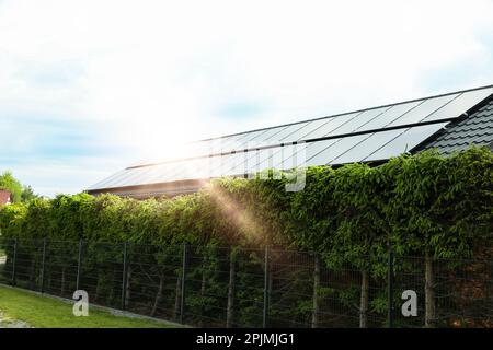 Solar panels installed on house roof outdoors. Alternative energy source Stock Photo