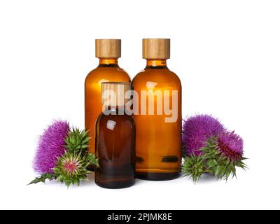 Bottles of essential oil and flowers on white background Stock Photo