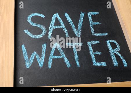Words Save Water written on blackboard, closeup Stock Photo